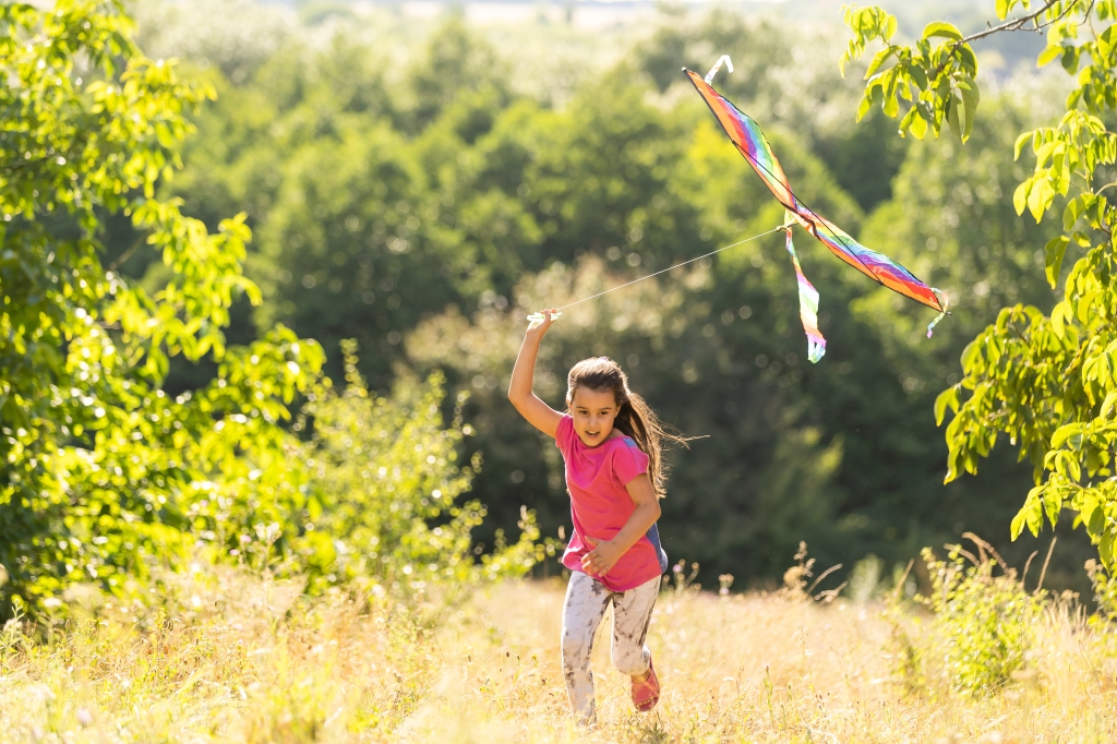 Little girl flying a kite